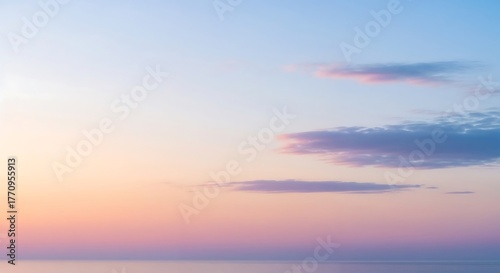 Peaceful pastel sunset sky above calm horizon.