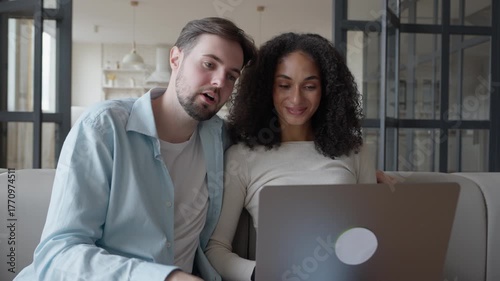 Smiling Couple Having Video Call Together On Laptop At Cozy Home Interior