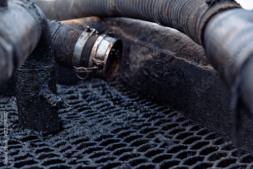 Close-up of industrial pipes with crude oil. oil and gas production concept
