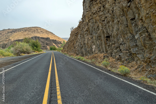 Highway 821 runs next to ancient volcanic rock formations near Roza, Washington, USA