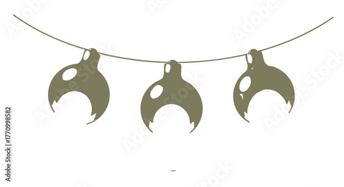 Three crescent-shaped ornaments hang from a thin string.