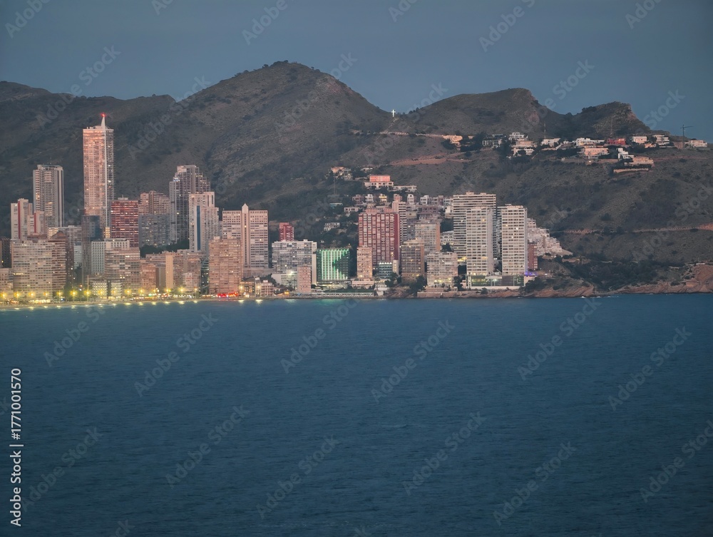 Fototapeta premium twilight seaside cityscape illuminated beautifully, sea view captures glowing urban horizon at dusk