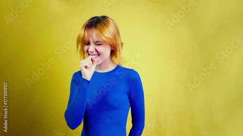 Joyful young woman with red hair dancing energetically