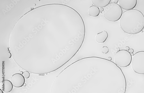 Abstract dynamic liquid art on an oil droplets pattern with beige grey silver light effaced, cozy art theme wallpaper background.