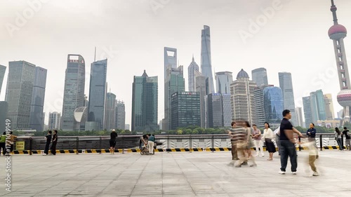 Timelapse of the Shanghai city skyline and tourists on the bund