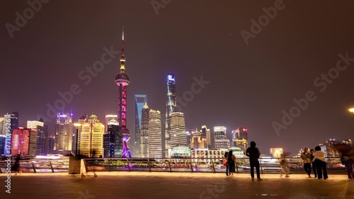 Timelapse of the Shanghai city skyline and tourists on the bund