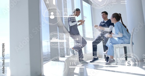 Leaning scrub-clad staff checking smartphone, sipping coffee in hospital breakroom, data overlays