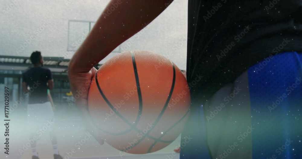 Fototapeta premium Player in sportswear holding basketball on rooftop court, with hoop and transparent backboard