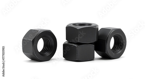 Four dark gray hexagonal metal nuts stacked and arranged on white hardware fastener
