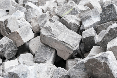 A pile of gray rocks with some of them broken