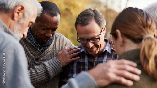 Individuals in a circle holding hands, group prayer, spiritual connection, outdoor meditation, unity, shared faith, community support, mutual guidance, seeking peace, emotional strength