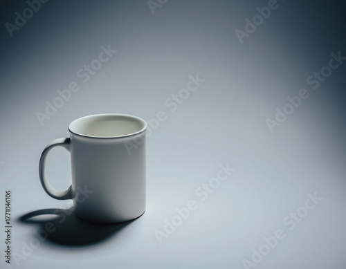 A single matte-white ceramic mug with a fine lip and soft shadow, positioned lower-left on a seamless pale gray backdrop; 70% negative space to the right for typography. Soft top-down key light, gentl
