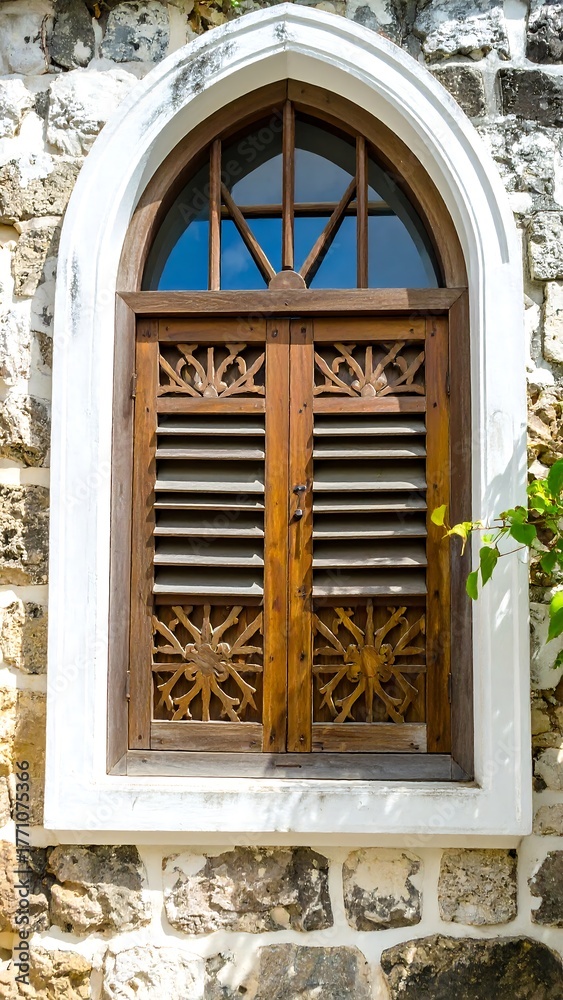 Fototapeta premium Ornate wooden window in stone wall