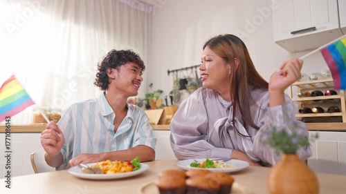 Asian transgender woman and her male partner enjoy breakfast in house. 