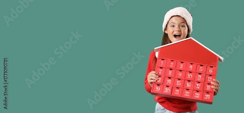 Excited girl in Santa hat a...