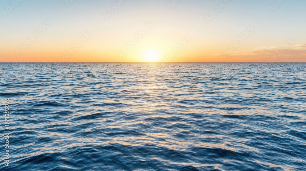 Obraz premium Sunrise over calm ocean waves creates serene and hopeful atmosphere