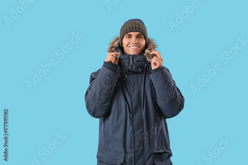 Young man in warm parka on ...