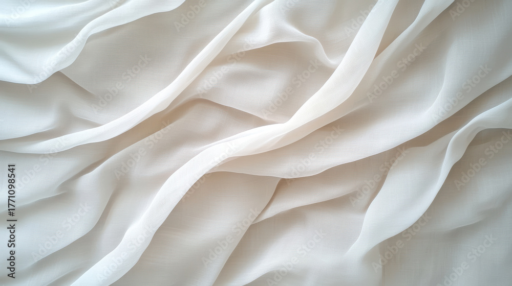 Obraz premium Soft white fabric drapes elegantly, showcasing delicate folds and textures