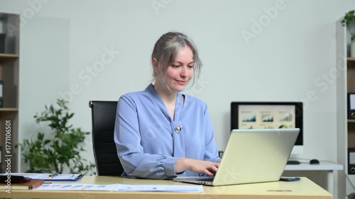 Successful businesswoman in modern office working on laptop.for doing math finance on an office desk, tax, report