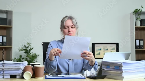 Successful businesswoman in modern office working on laptop.for doing math finance on an office desk, tax, report