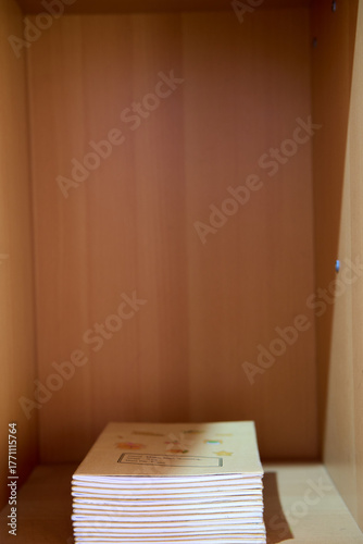 Single Book Leaning in Empty Wooden Shelf