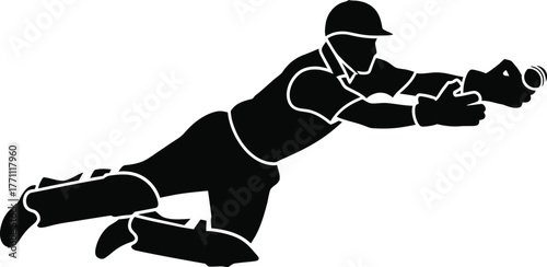 Silhouette of a cricket player diving to catch a ball