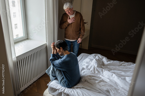 Canvas-taulu Senior husband sharing heartbreaking news with sorrow partner weeping in emotional distress at home