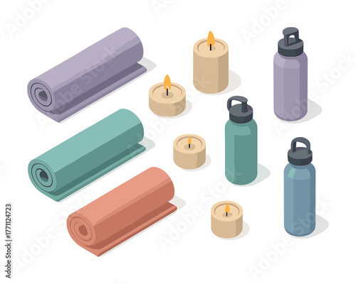 Yoga mats and accessories with water bottles and candles on white background