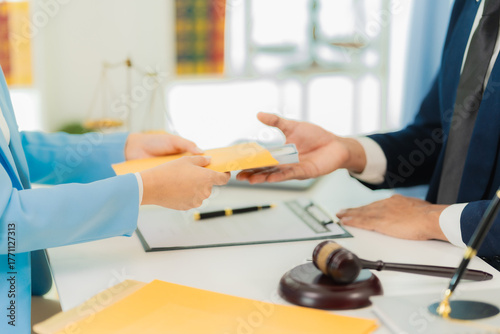 Businessman bribes lawyer to help lawyer win case. Officials accept bribes for special benefits from clients and competitors in corruption case. Close-up.