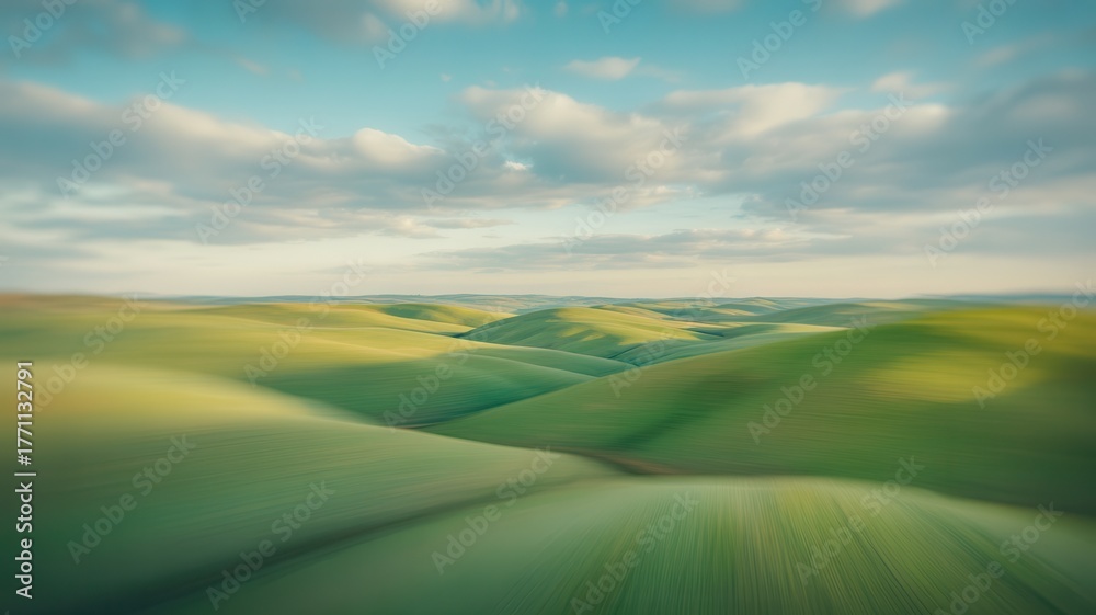 Fototapeta premium Softly blended abstract landscape with verdant rolling hills under a cloudy sky