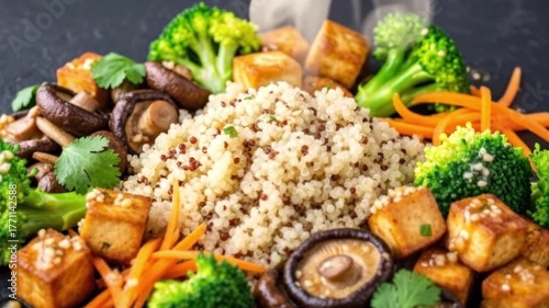 Quinoa dish w tofu broccoli carrots  mushrooms arranged artfully on a dark surface Steam rises subtly