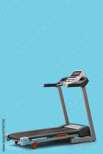 Modern treadmill on blue ba...