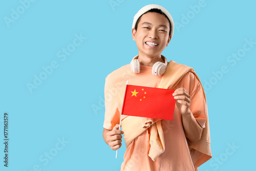 Young Asian man with flag o...