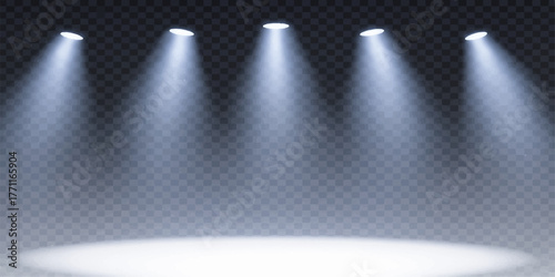 Empty gray theater stage illuminated by a single spotlight on a dark backdrop wall