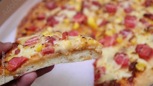 This hot, cheesy beef pizza is ready to be served on a wooden board.

