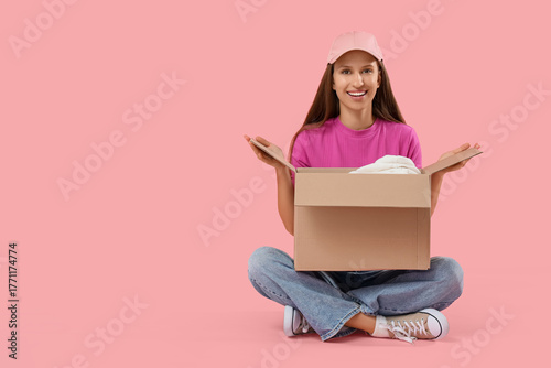 Young woman with cardboard ...