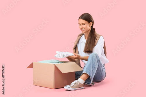 Young woman unpacking cardb...