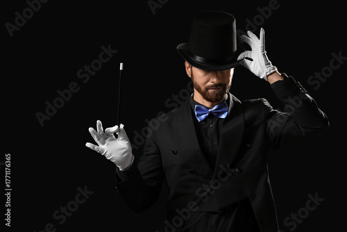 Male magician with wand on ...