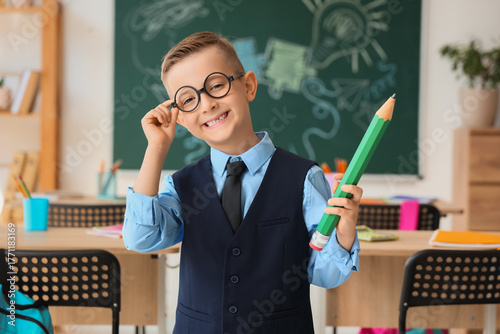 Cute little schoolboy with ...