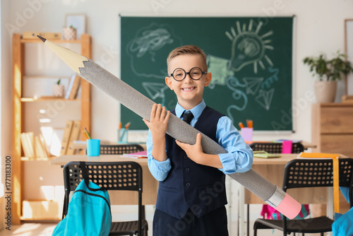 Cute little schoolboy with ...