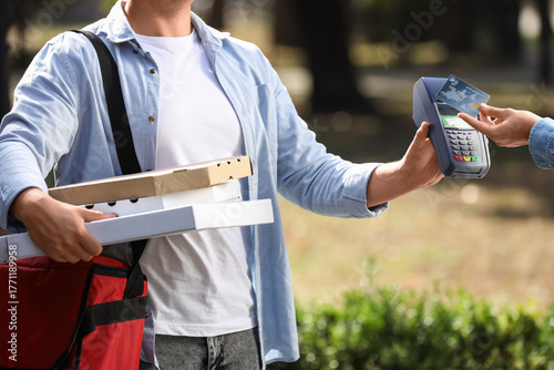 Male courier with pizza box...