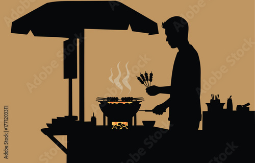 Silhouette of a Street Food Vendor Grilling Satay
