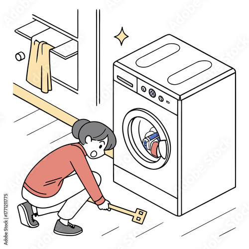 A woman is diligently cleaning dust and debris from under a front-loading washing machine in a laundry room, using a long-handled cleaning tool.