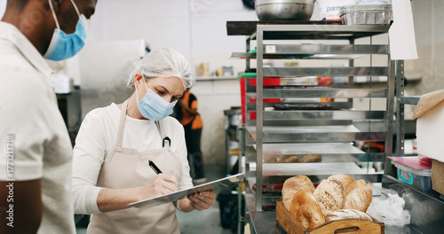 Health, inspection or people in cafe with clipboard, hygiene or food safety in checklist. Sanitation, review or inspector in kitchen with writing, quality control or compliance in restaurant service.