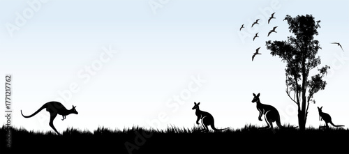 silhouette of kangaroos and birds across grassland  pale blue background