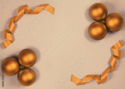 Beautiful Christmas Background with Shiny orange brown Balls and Ribbon in Bright Color. Top view with Copy Space. Sepia tinting in the style of old vintage postcards. Old-fashioned, retro