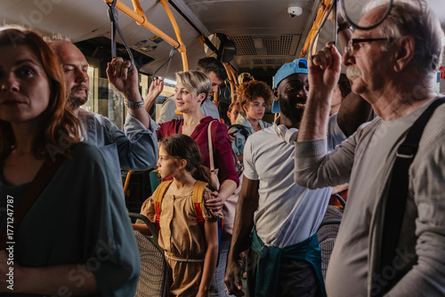 Diverse people commuting everyday life on crowded public bus