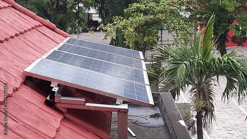 Solar Panels on Red Tiled Roof of Building in the Morning
