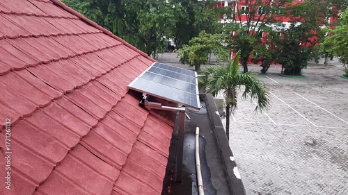Solar Panels on Red Tiled Roof of Building in the Morning