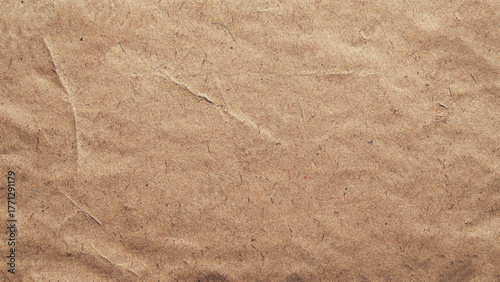 Background of brown kraft paper or cardboard texture. Abstract pattern of beige rough carton, old paper sheet. Old brown vintage paper texture background